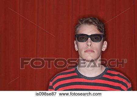 Stock Photo - Portrait of young man against red background. Fotosearch