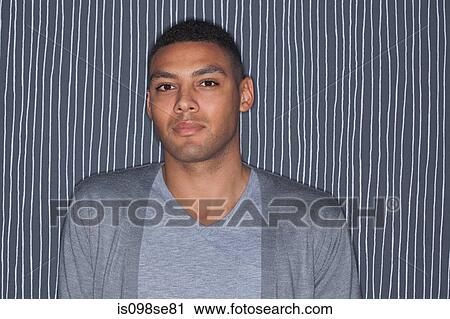 Portrait of young man against striped background View Large Photo Image Stock Image - Portrait of young man against striped background. Fotosearch