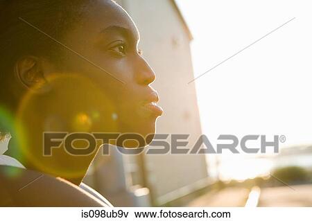 Profile of a young woman in sunlight View Large Photo Image Stock Photo - Profile of a young woman in sunlight. Fotosearch