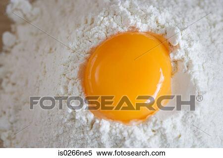 Stock Photography - Raw egg and flour. Fotosearch