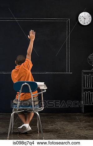Picture - Rear view of a boy with his arm raised. Fotosearch