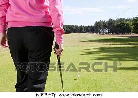 Stock Photography - Rear view of a female golfer. Fotosearch