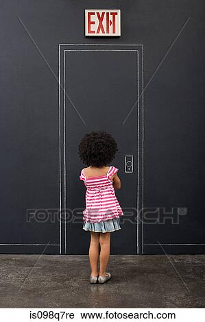 Stock Image - Rear view of a girl and a door. Fotosearch