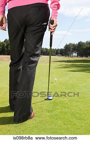 Stock Image - Rear view of a golfer. Fotosearch