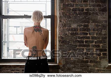 Stock Photo - Rear view of a woman with tattoos. Fotosearch