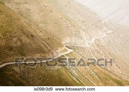 Stock Photo - Road winding through mountains. Fotosearch