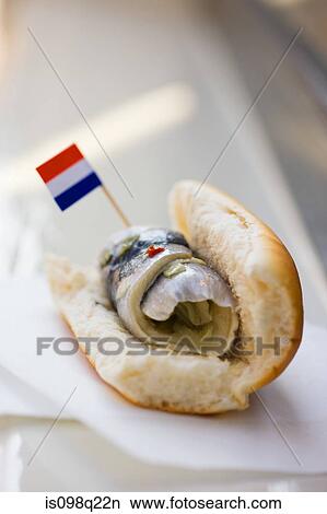 Picture - Rollmop in a bread roll. Fotosearch