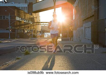 Stock Image - Runner and sunlight. Fotosearch