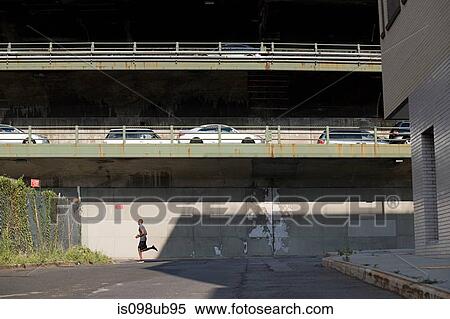 Stock Photography - Runner below and cars above. Fotosearch