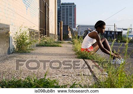 Runner sitting on sidewalk View Large Photo Image Picture - Runner sitting on sidewalk. Fotosearch