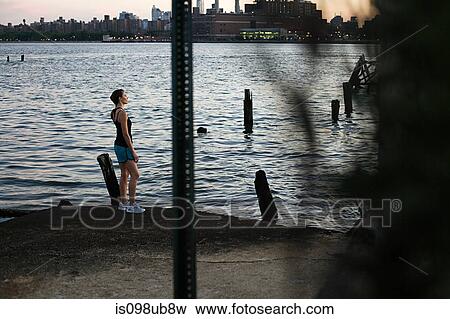 Runner standing by river in brooklyn View Large Photo Image Stock Photo - Runner standing by river in brooklyn. Fotosearch