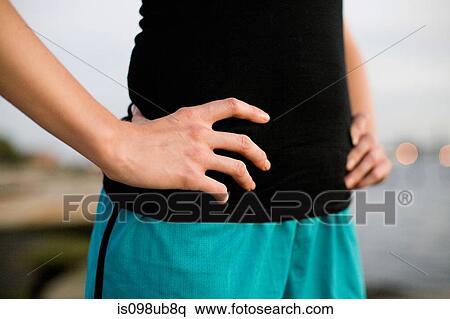 Stock Photography - Runner with hands on hips in close up. Fotosearch