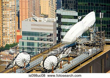 Stock Photo - Satellite dishes and buildings in New York. Fotosearch