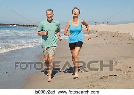 Senior couple jogging on beach View Large Photo Image Stock Image - Senior couple jogging on beach. Fotosearch