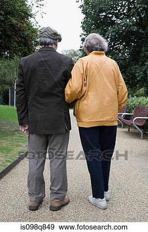 Senior couple walking in park View Large Photo Image Stock Photo - Senior couple walking in park. Fotosearch