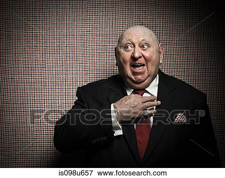 Senior man adjusting tie against dogtooth check background View Large Photo Image Stock Photo - Senior man adjusting tie against dogtooth check background. Fotosearch