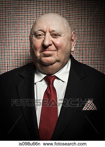 Senior man against dogtooth check background, with matching handkerchief View Large Photo Image Picture - Senior man against dogtooth check background, with matching handkerchief. Fotosearch