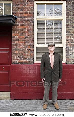 Stock Photo - Senior man outside building. Fotosearch