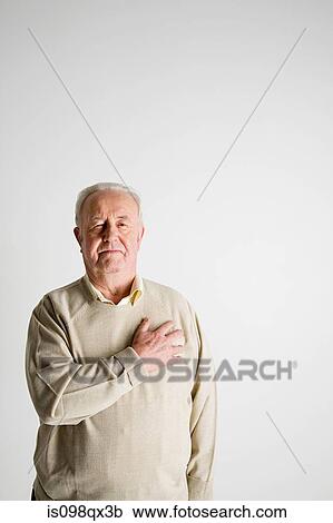 Stock Image - Senior man with hand on heart. Fotosearch
