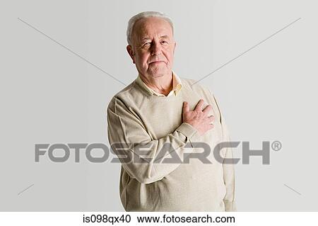Senior man with hand on heart View Large Photo Image Stock Image - Senior man with hand on heart. Fotosearch