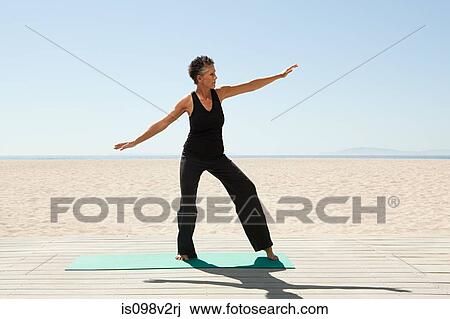 Senior woman doing yoga on beach View Large Photo Image Stock Image - Senior woman doing yoga on beach. Fotosearch