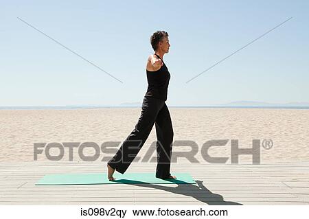 Senior woman doing yoga on beach View Large Photo Image Stock Photo - Senior woman doing yoga on beach. Fotosearch