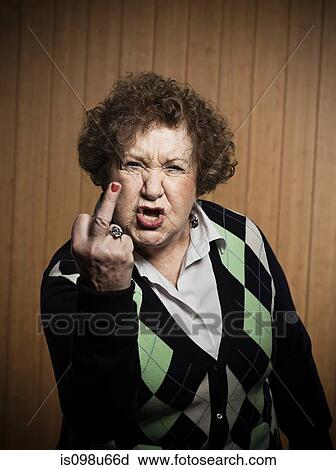 Stock Image - Senior woman making obscene gesture. Fotosearch