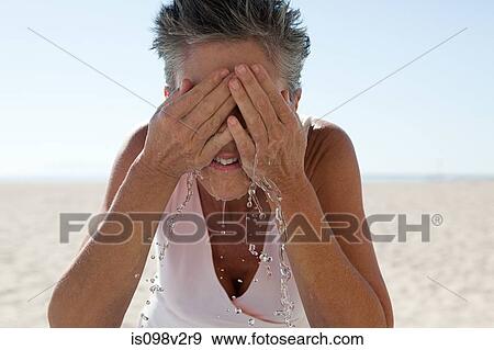 Stock Photo - Senior woman washing face. Fotosearch
