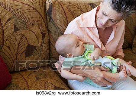 Stock Image - Senior woman with baby grandson. Fotosearch