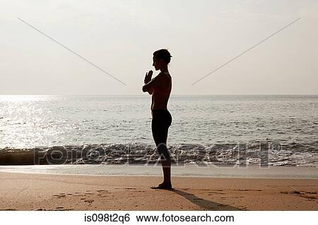 Silhouette of woman by sea in prayer pose View Large Photo Image Stock Photograph - Silhouette of woman by sea in prayer pose. Fotosearch