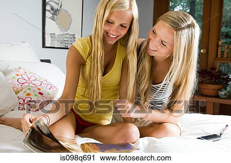 Sisters with magazine View Large Photo Image Stock Image - Sisters with magazine. Fotosearch