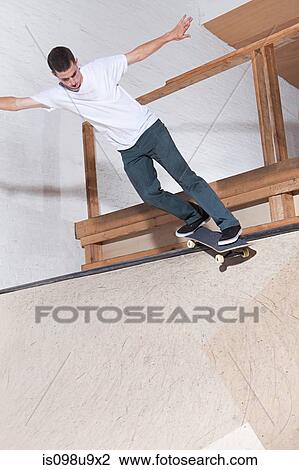 Stock Image - Skateboarder on ramp at skate park. Fotosearch