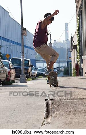 Skateboarder on urban street View Large Photo Image Stock Photo - Skateboarder on urban street. Fotosearch