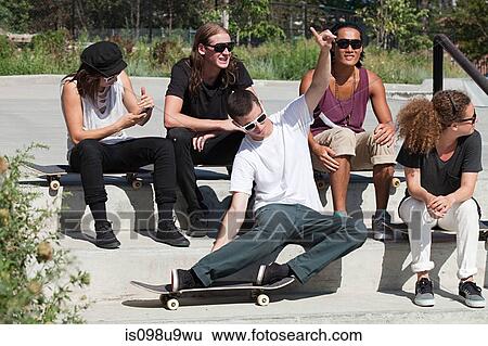 Stock Photograph - Skateboarders at skate park. Fotosearch