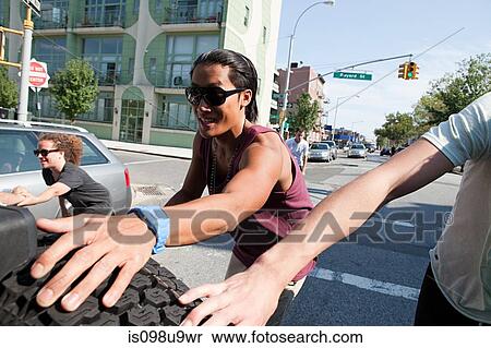 Skateboarders holding on to tyre on back of car View Large Photo Image Stock Photography - Skateboarders holding on to tyre on back of car. Fotosearch
