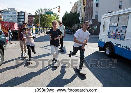 Skateboarders on urban street View Large Photo Image Picture - Skateboarders on urban street. Fotosearch