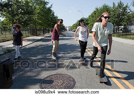 Picture - Skateboarders on urban street. Fotosearch