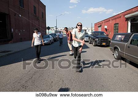 Skateboarders on urban street View Large Photo Image Stock Photo - Skateboarders on urban street. Fotosearch