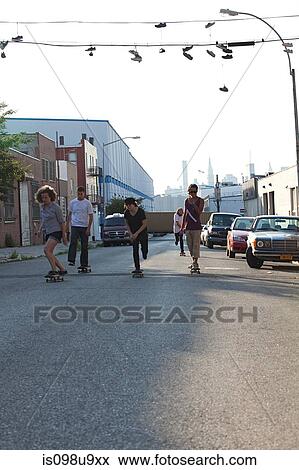Skateboarders on urban street View Large Photo Image Stock Photo - Skateboarders on urban street. Fotosearch