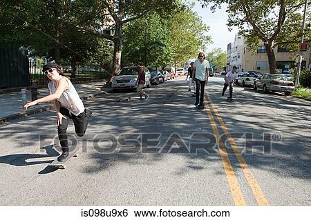 Stock Photograph - Skateboarders on urban street. Fotosearch