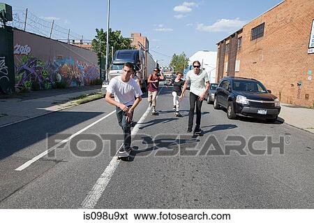 Stock Photograph - Skateboarders on urban street. Fotosearch