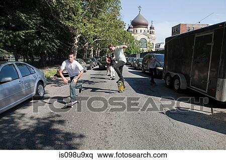 Skateboarders on urban street View Large Photo Image Stock Photography - Skateboarders on urban street. Fotosearch