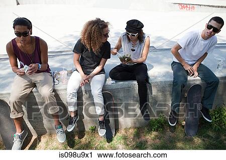 Skateboarders taking a break View Large Photo Image Stock Image - Skateboarders taking a break. Fotosearch