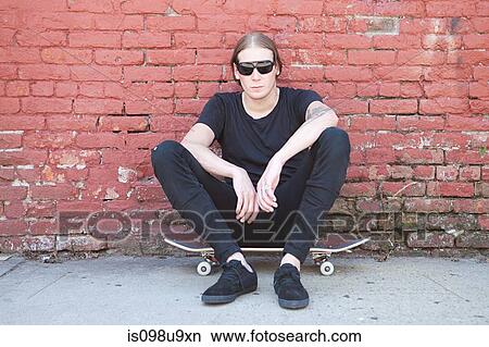 Skater sitting on board View Large Photo Image Picture - Skater sitting on board. Fotosearch