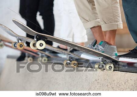 Stock Photograph - Skaters and their boards. Fotosearch