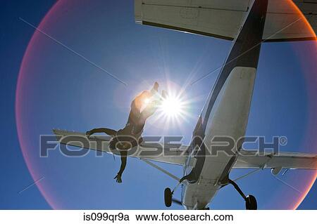 Skydiver falling from airplane with sunlight View Large Photo Image Stock Image - Skydiver falling from airplane with sunlight. Fotosearch