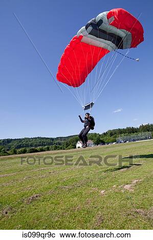 Skydiver landing with parachute View Large Photo Image Stock Image - Skydiver landing with parachute. Fotosearch