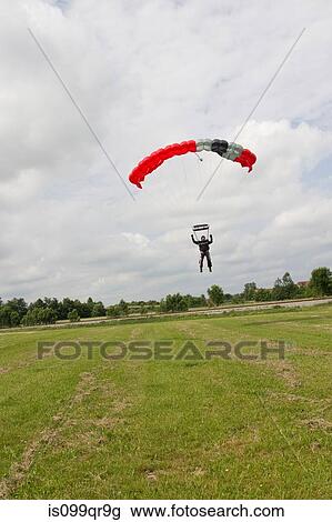 Skydiver landing with parachute View Large Photo Image Stock Image - Skydiver landing with parachute. Fotosearch