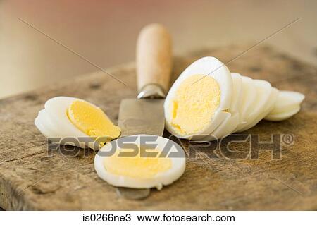 Sliced egg and a knife View Large Photo Image Stock Image - Sliced egg and a knife. Fotosearch