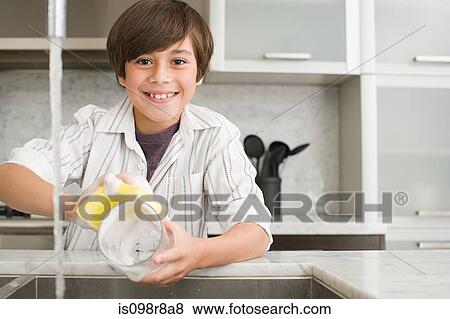Stock Photo - Smiling boy washing up. Fotosearch